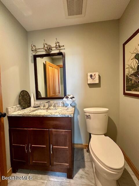 26 A Stonebridge Way Tyringham, MA 01238 - Photo 25 of 74 a bathroom with a toilet a sink and mirror