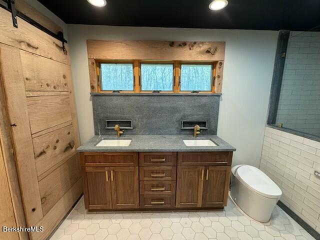 26 A Stonebridge Way Tyringham, MA 01238 - Photo 29 of 74 a bathroom with a granite countertop sink a toilet and a mirror