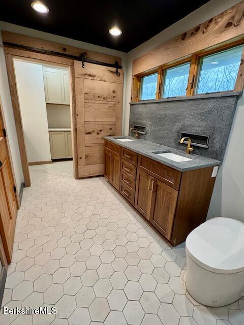 26 A Stonebridge Way Tyringham, MA 01238 - Photo 30 of 74 a bathroom with a sink a toilet and mirror