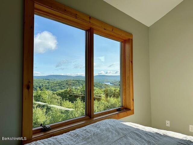 26 A Stonebridge Way Tyringham, MA 01238 - Photo 37 of 74 a view of an empty room with wooden floor and a window
