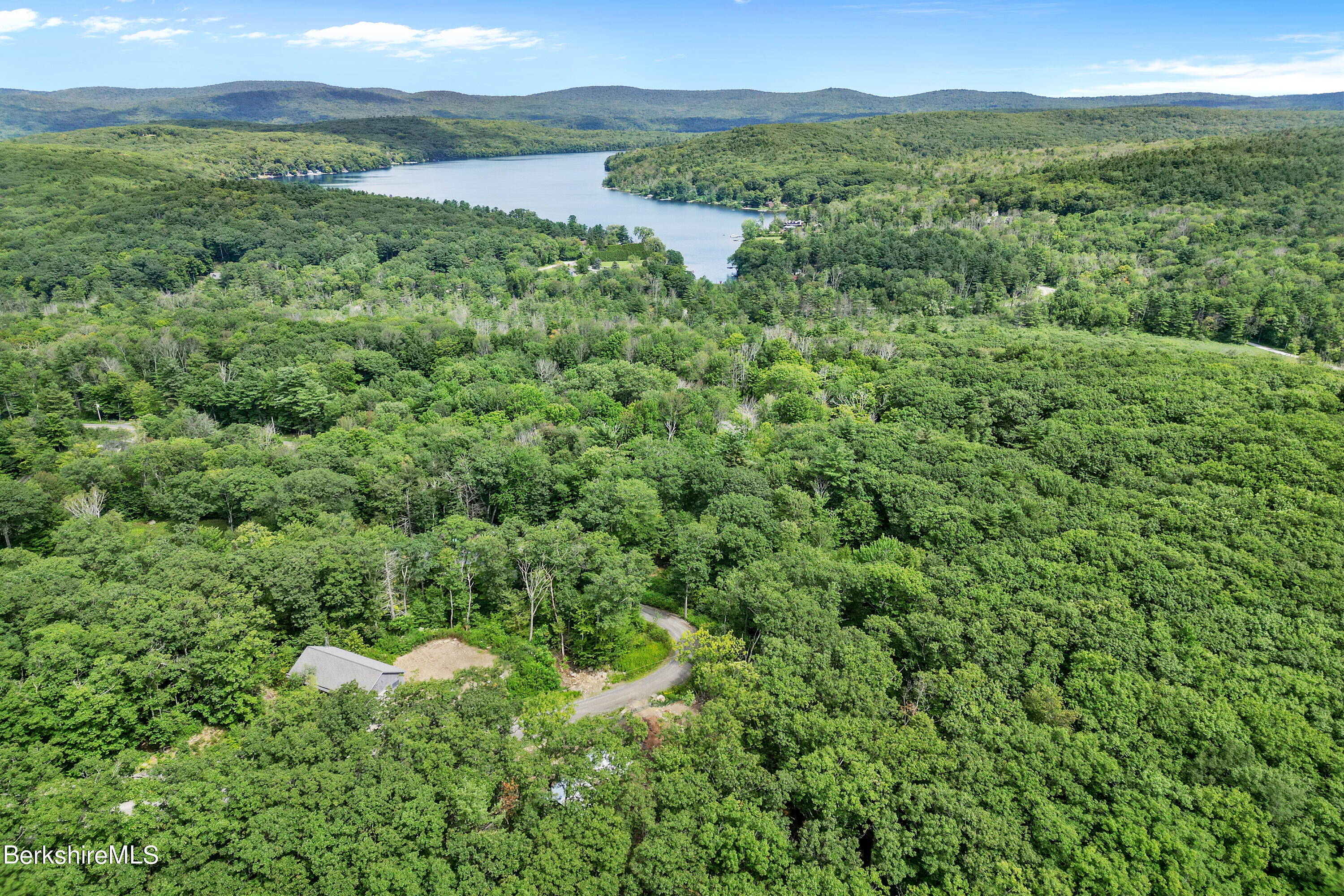 26 A Stonebridge Way Tyringham, MA 01238 - Photo 39 of 74 a view of a lush green outdoor space with a lake view and mountain view