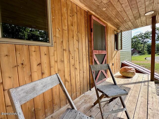 26 A Stonebridge Way Tyringham, MA 01238 - Photo 6 of 74 a view of a balcony with furniture and floor to ceiling window
