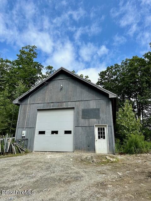 26 A Stonebridge Way Tyringham, MA 01238 - Photo 61 of 74 a house with trees in the background