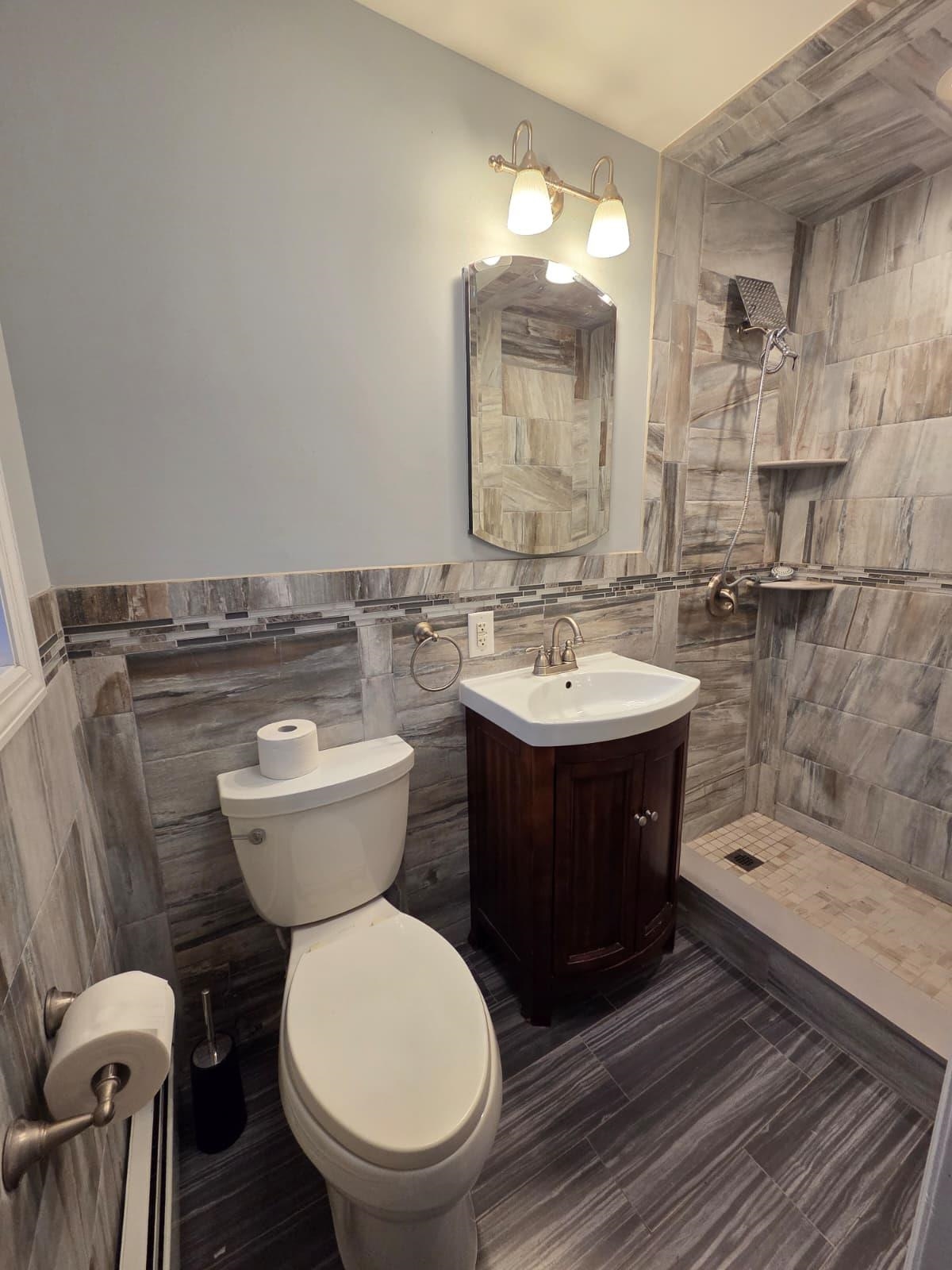 730 5th Street, Unit 2 Carlstadt, NJ 07072 - Photo 11 of 15 a bathroom with a toilet a sink and mirror