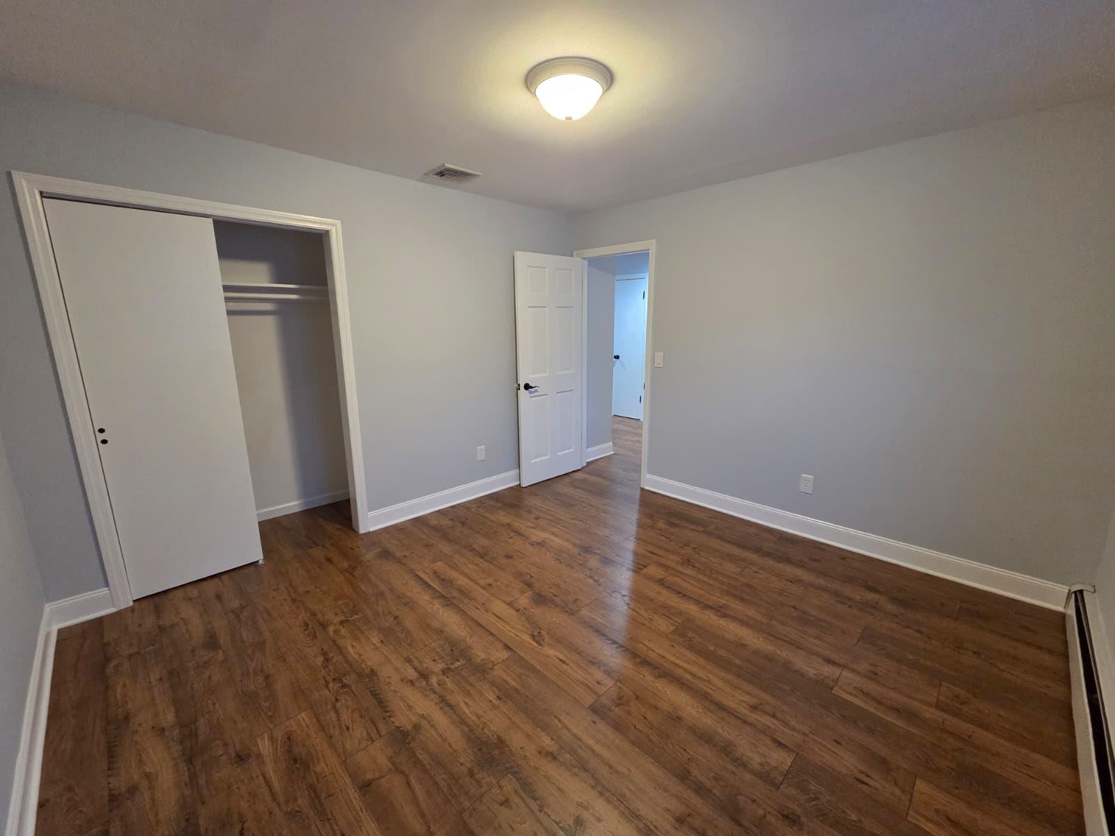 730 5th Street, Unit 2 Carlstadt, NJ 07072 - Photo 13 of 15 a view of an empty room with wooden floor and closet