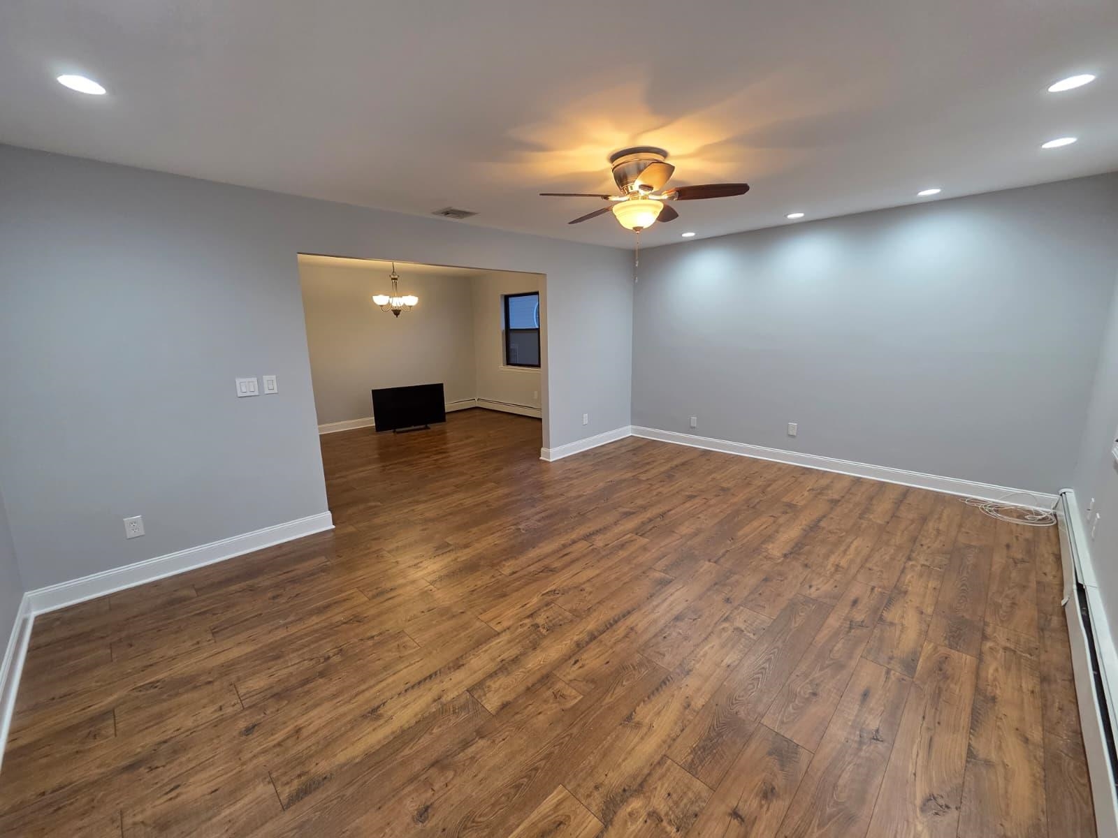 730 5th Street, Unit 2 Carlstadt, NJ 07072 - Photo 5 of 15 an empty room with wooden floor and windows