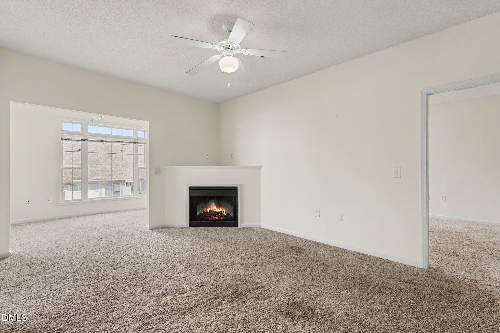 2521 Friedland Place Raleigh, NC 27617 - Photo 7 of 21 Open-concept living area centered around a cozy fireplace. Flexible layout options for full sectional seating, media center, or entertainment space.