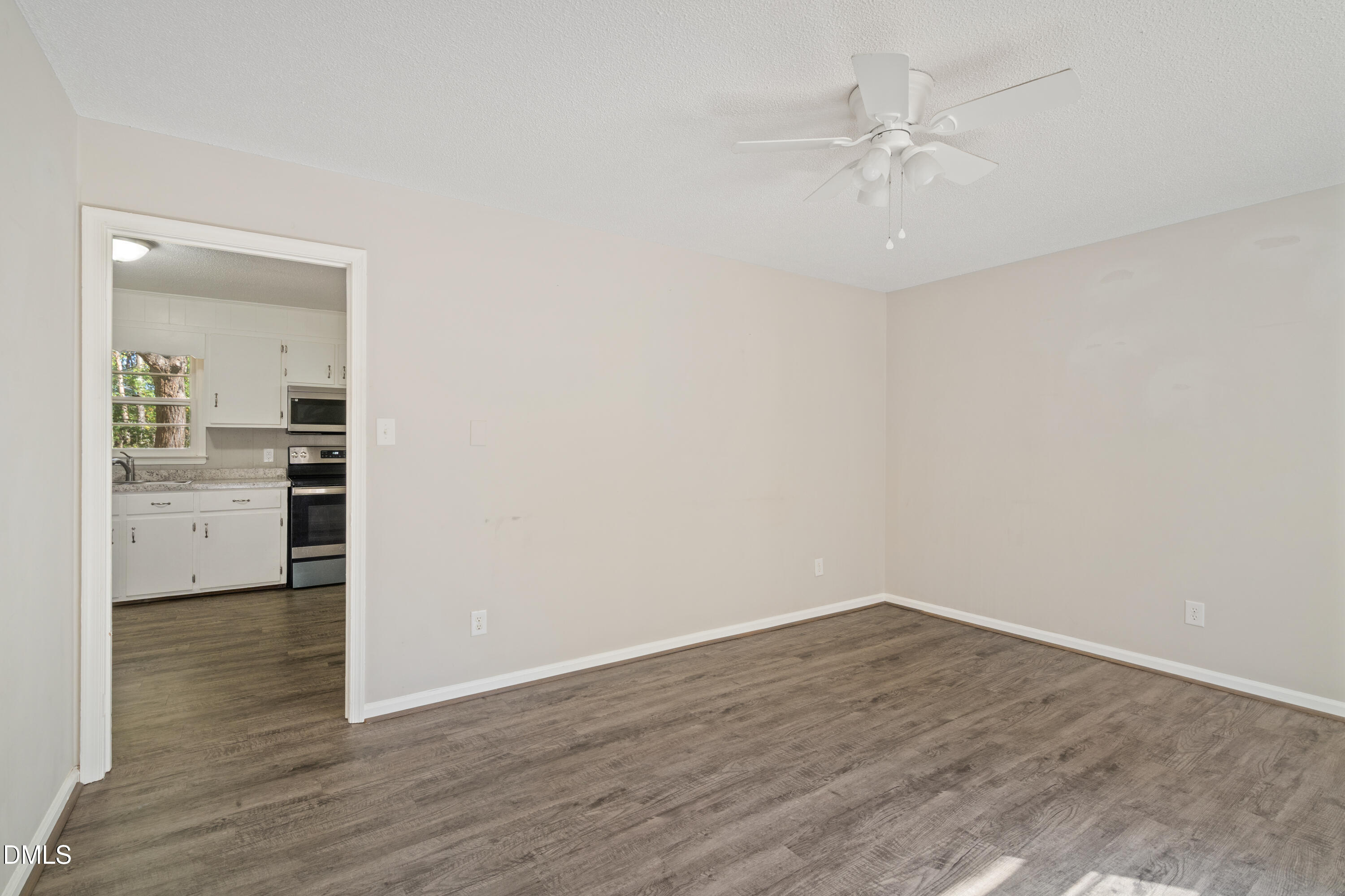 70 Lynnbank Estates Road Kittrell, NC 27544 - Photo 4 of 21 wooden floor in an empty room and a kitchen