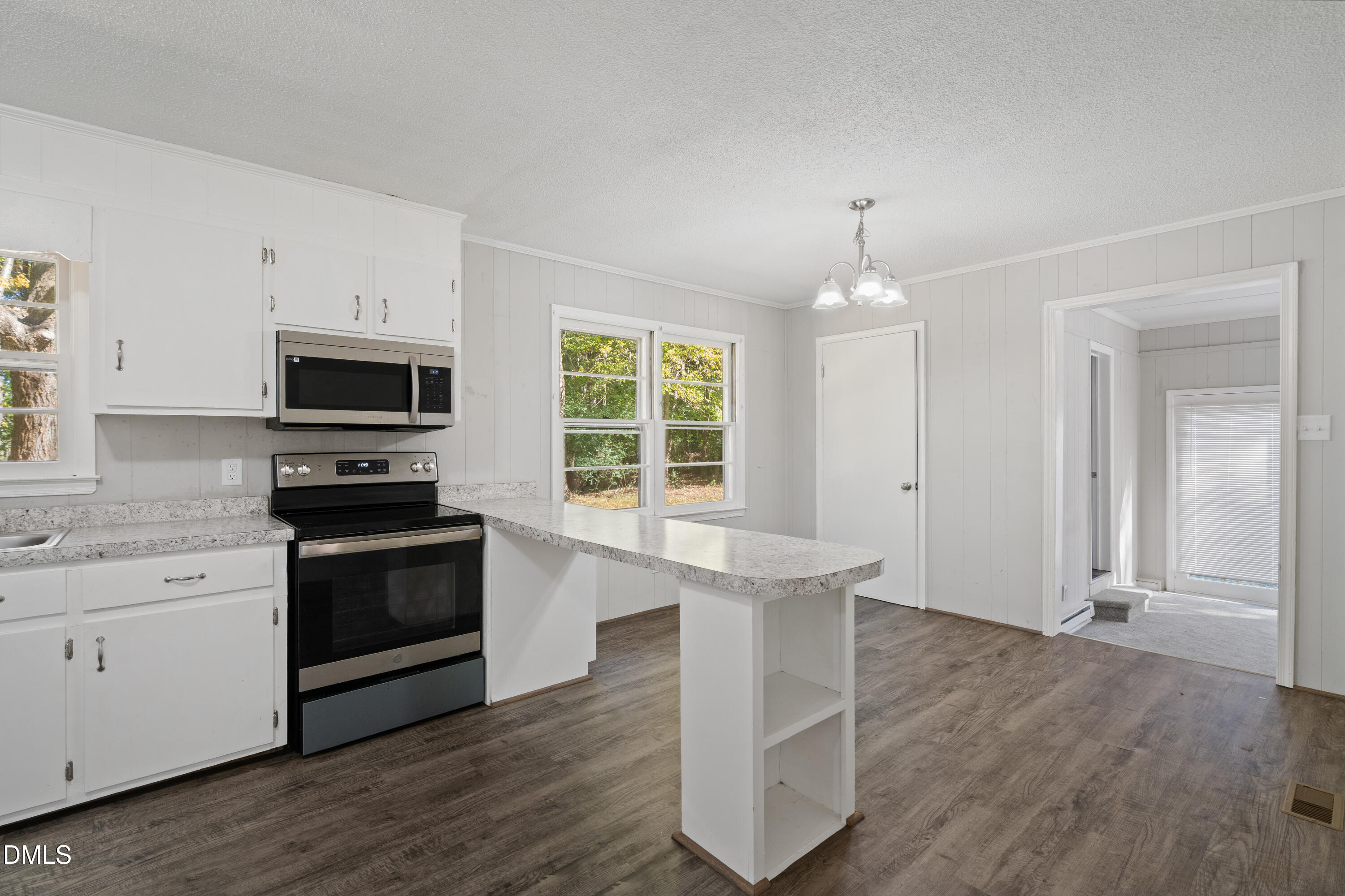 70 Lynnbank Estates Road Kittrell, NC 27544 - Photo 6 of 21 a kitchen with granite countertop a stove a sink and a microwave