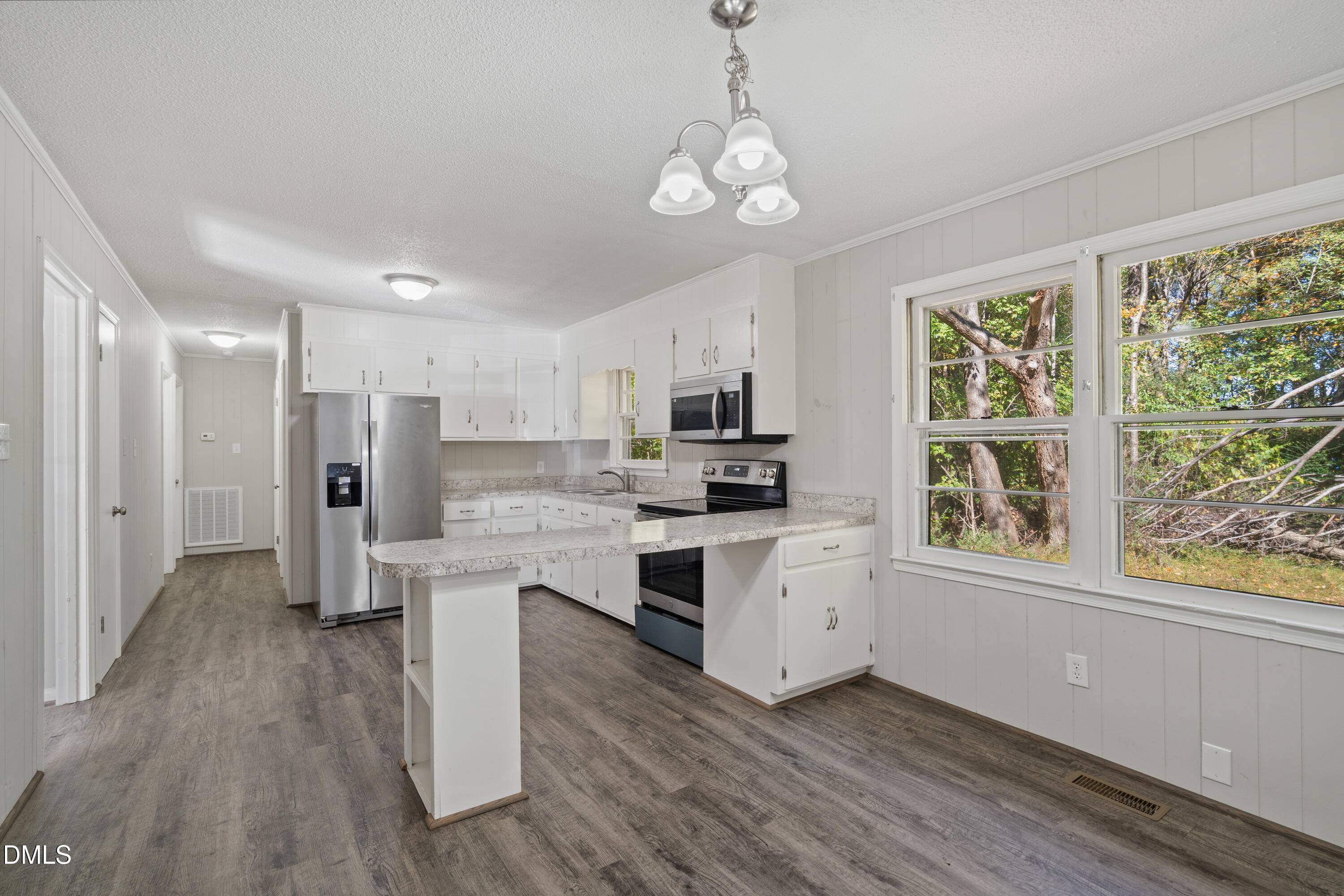 70 Lynnbank Estates Road Kittrell, NC 27544 - Photo 8 of 21 a large white kitchen with stainless steel appliances granite countertop a stove a sink dishwasher a refrigerator white cabinets and wooden floor