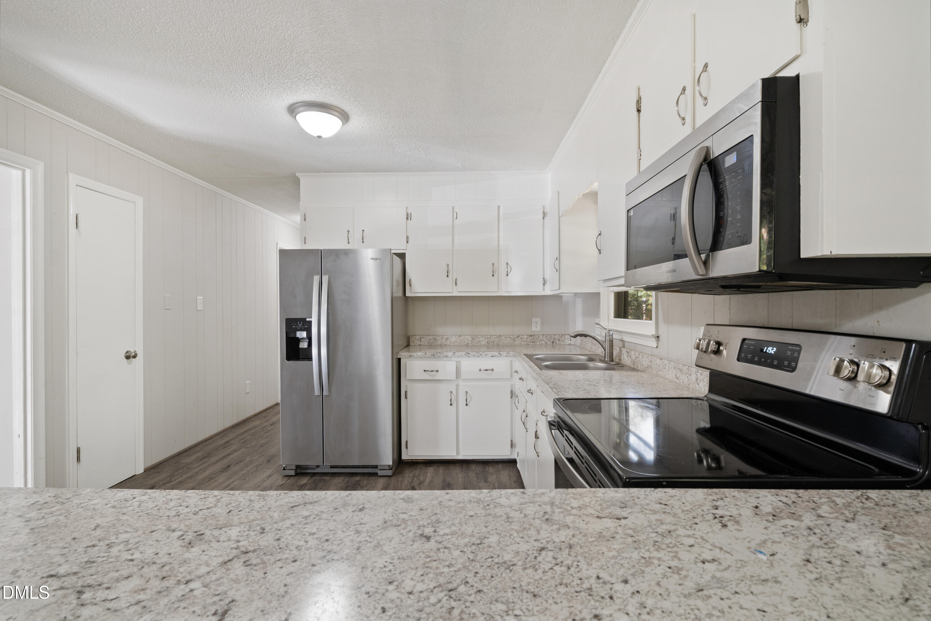 70 Lynnbank Estates Road Kittrell, NC 27544 - Photo 9 of 21 a kitchen with stainless steel appliances granite countertop a refrigerator a stove a sink and a microwave