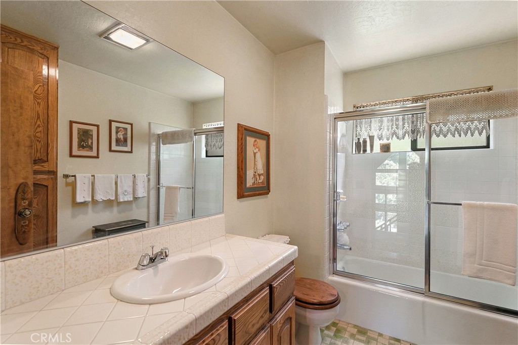 329 Grass Valley Road Lake Arrowhead, CA 92352 - Photo 18 of 31 a bathroom with a sink a toilet and shower