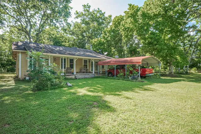 a front view of house with yard and green space