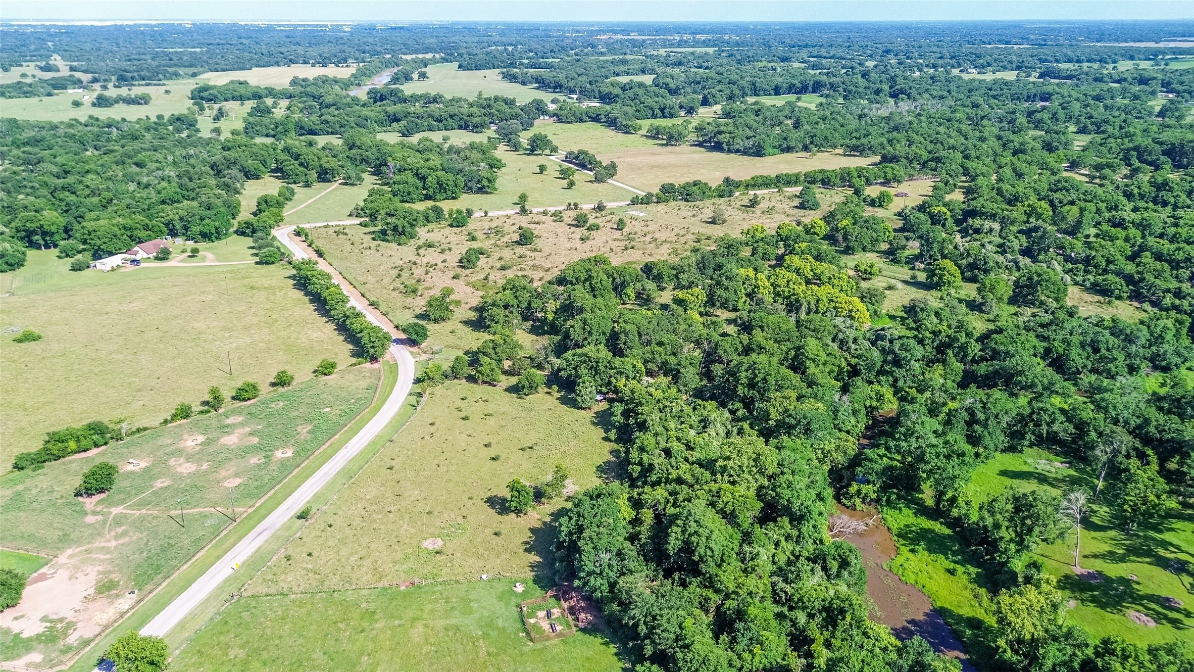 2511 Hartwell Road Brookshire, TX 77423 - Photo 32 of 40 an aerial view of residential houses with outdoor space and trees