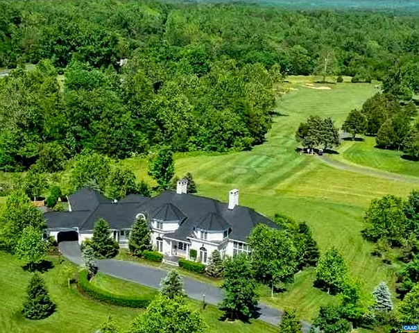 an aerial view of a house with yard swimming pool and outdoor seating