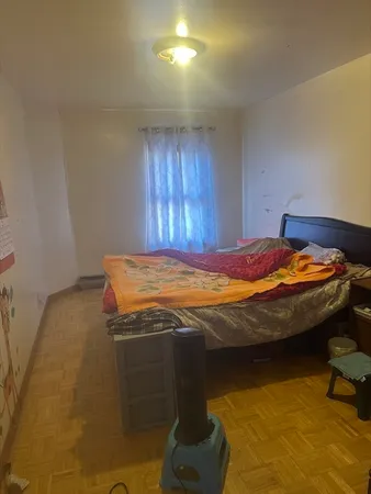 a bedroom with a bed and dresser