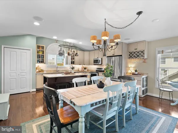 a kitchen with a stove a table and chairs in it