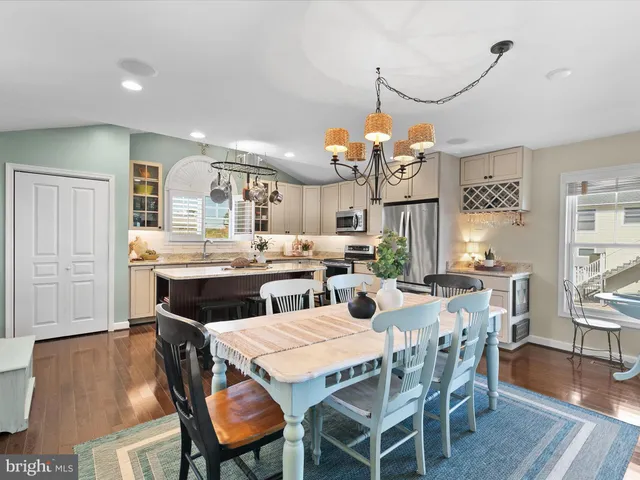 a kitchen with a stove a table and chairs in it