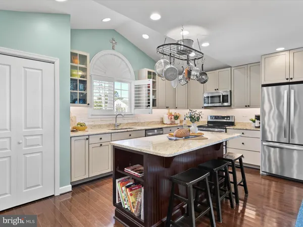 a view of a dining room with furniture wooden floor and chandelier
