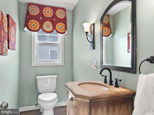 a living room with hard wood floors and furniture