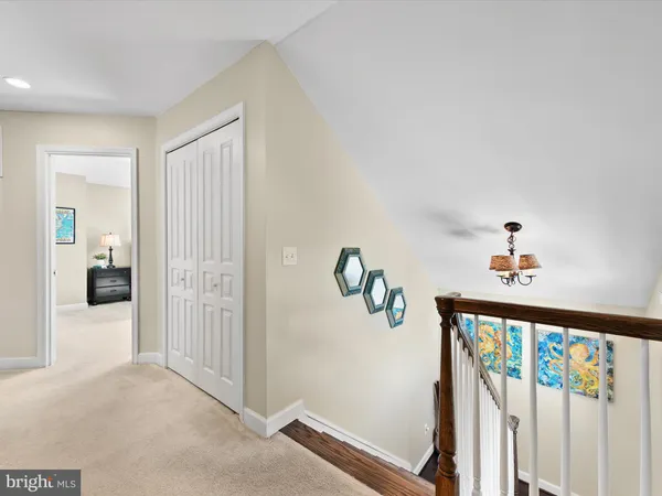 a bathroom with a granite countertop sink a toilet and a mirror