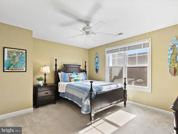 a bathroom with a granite countertop toilet a sink and a mirror