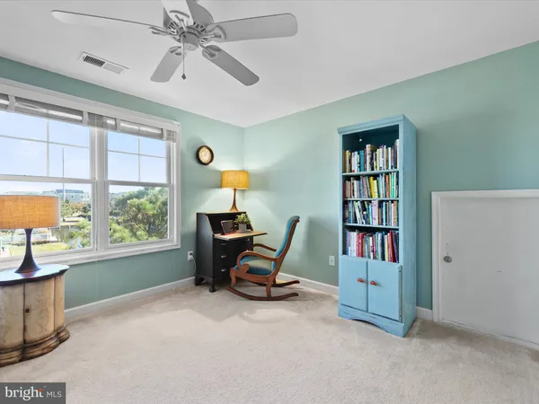 a view of a workspace with furniture and a window