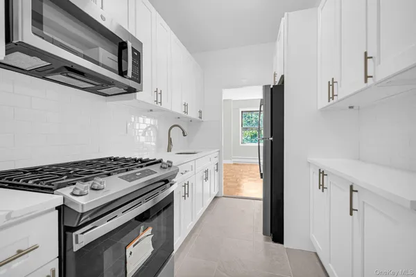 a kitchen with a sink and a refrigerator