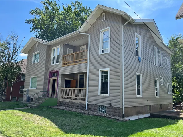 a view of backyard with plants and outdoor seating