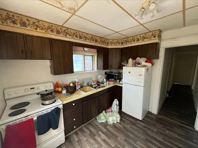 a room with a sink cabinets and utility