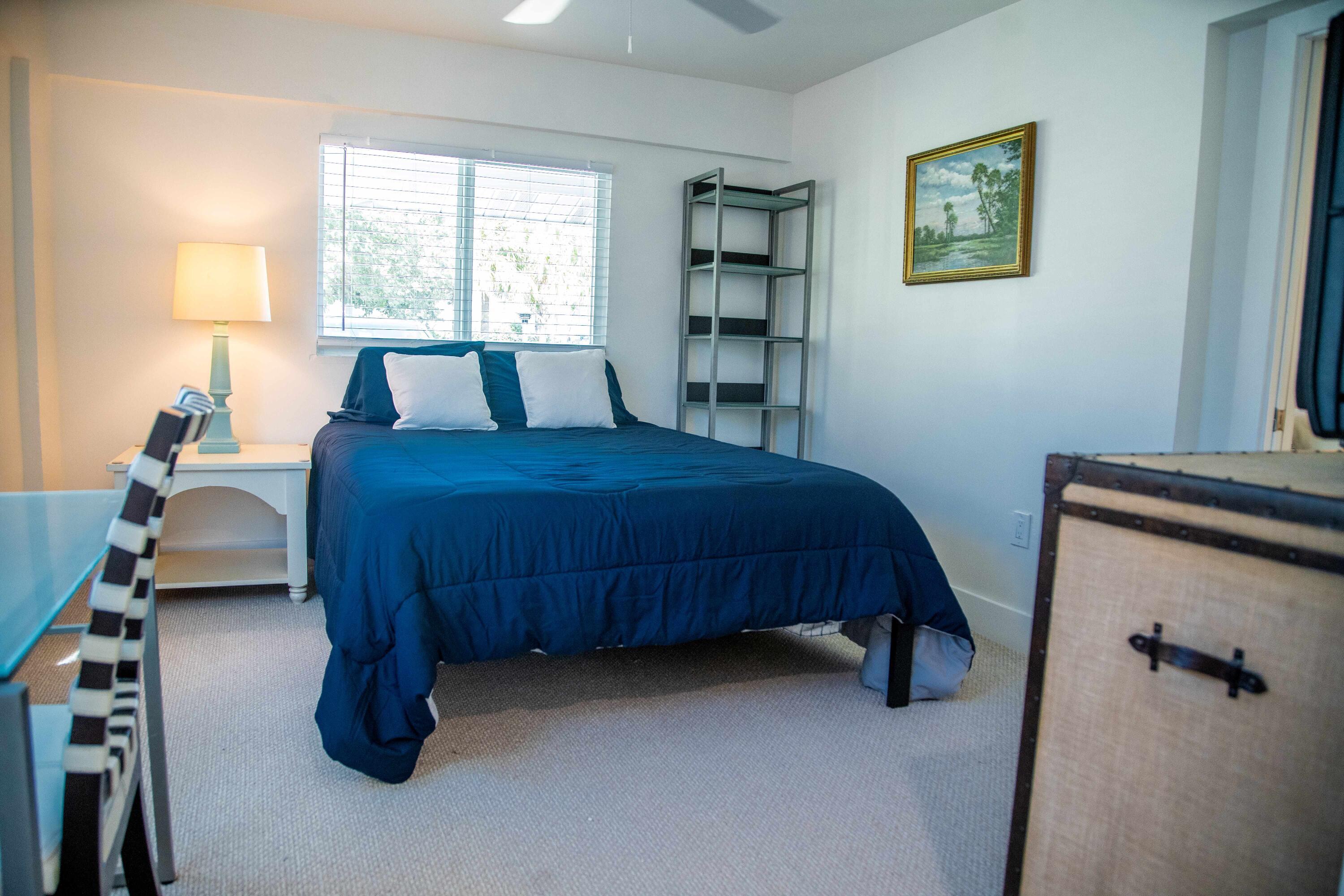 22 Van Road Jupiter, FL 33469 - Photo 15 of 38 a bedroom with a bed and a furniture