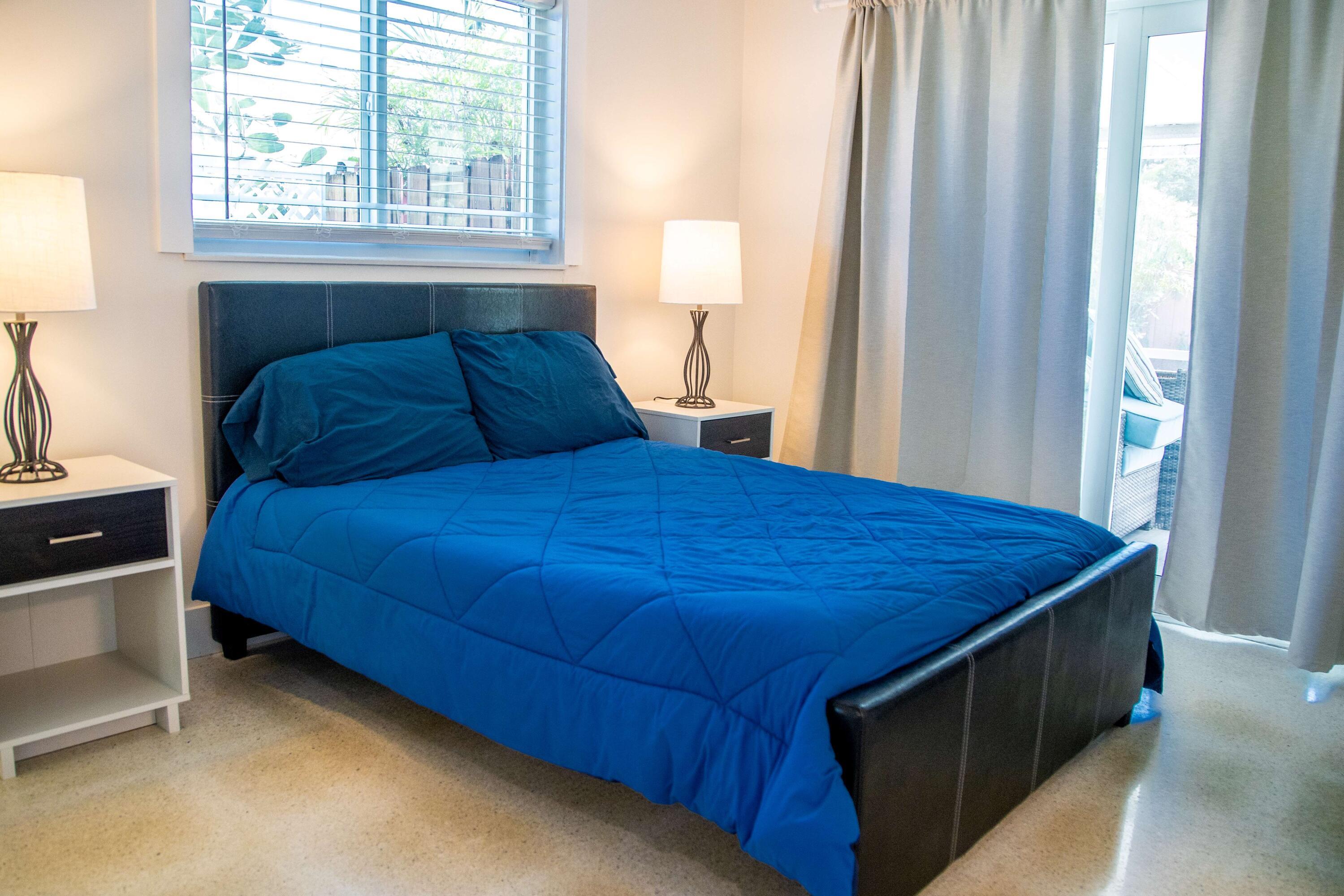 22 Van Road Jupiter, FL 33469 - Photo 2 of 38 a bedroom with a bed and a window