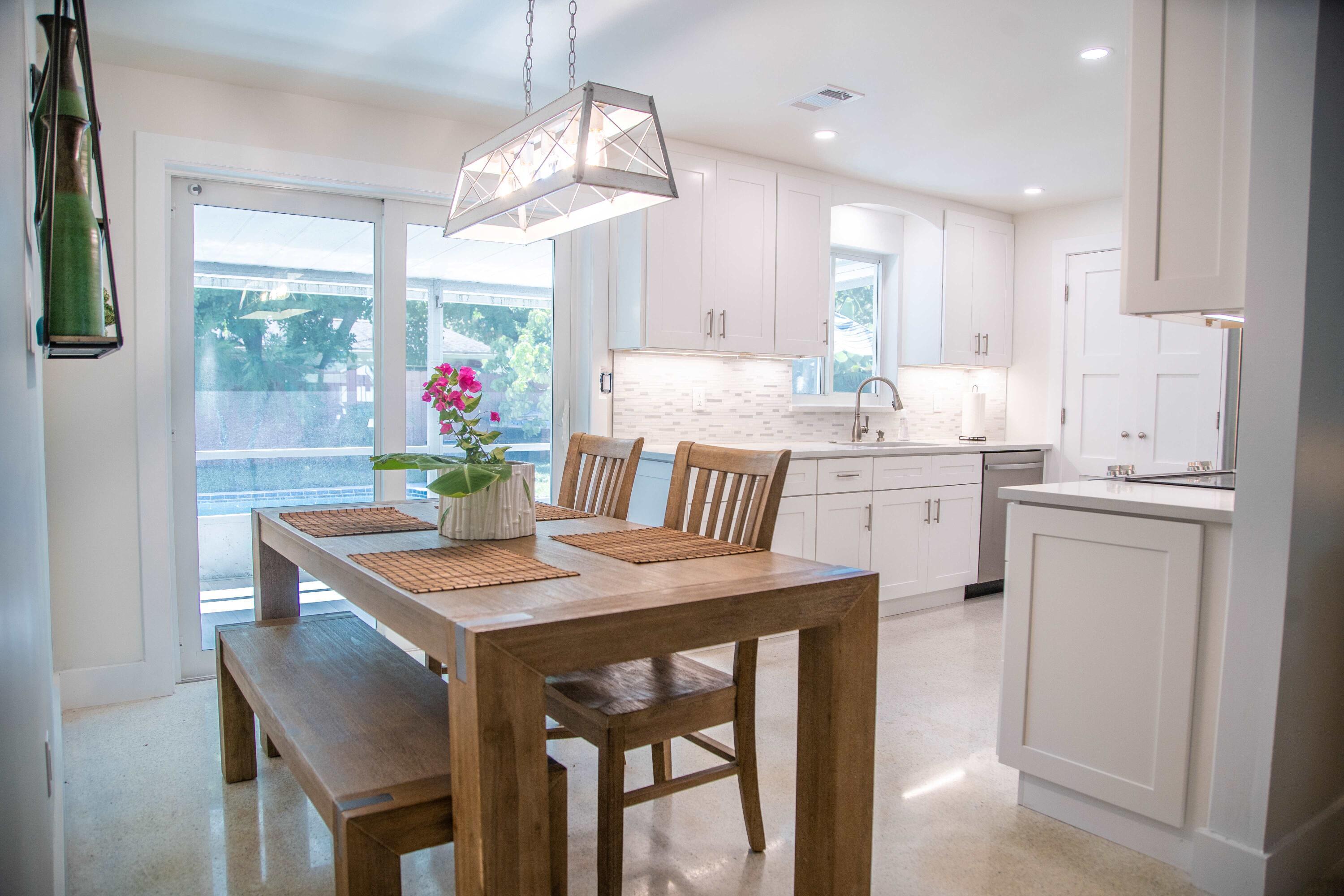 22 Van Road Jupiter, FL 33469 - Photo 21 of 38 a view of a dining room with furniture a chandelier and wooden floor