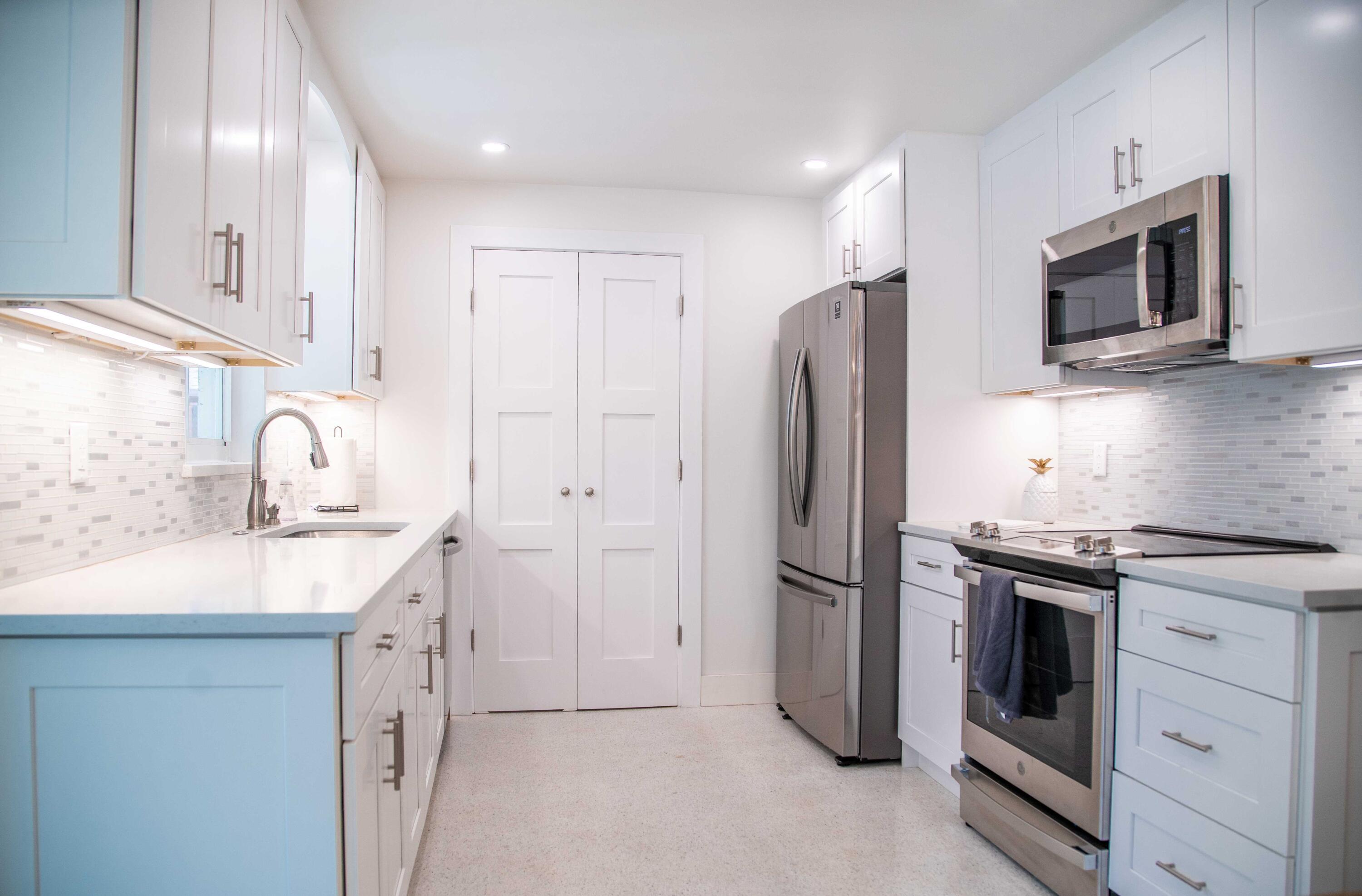22 Van Road Jupiter, FL 33469 - Photo 23 of 38 a kitchen with stainless steel appliances granite countertop a refrigerator and a sink