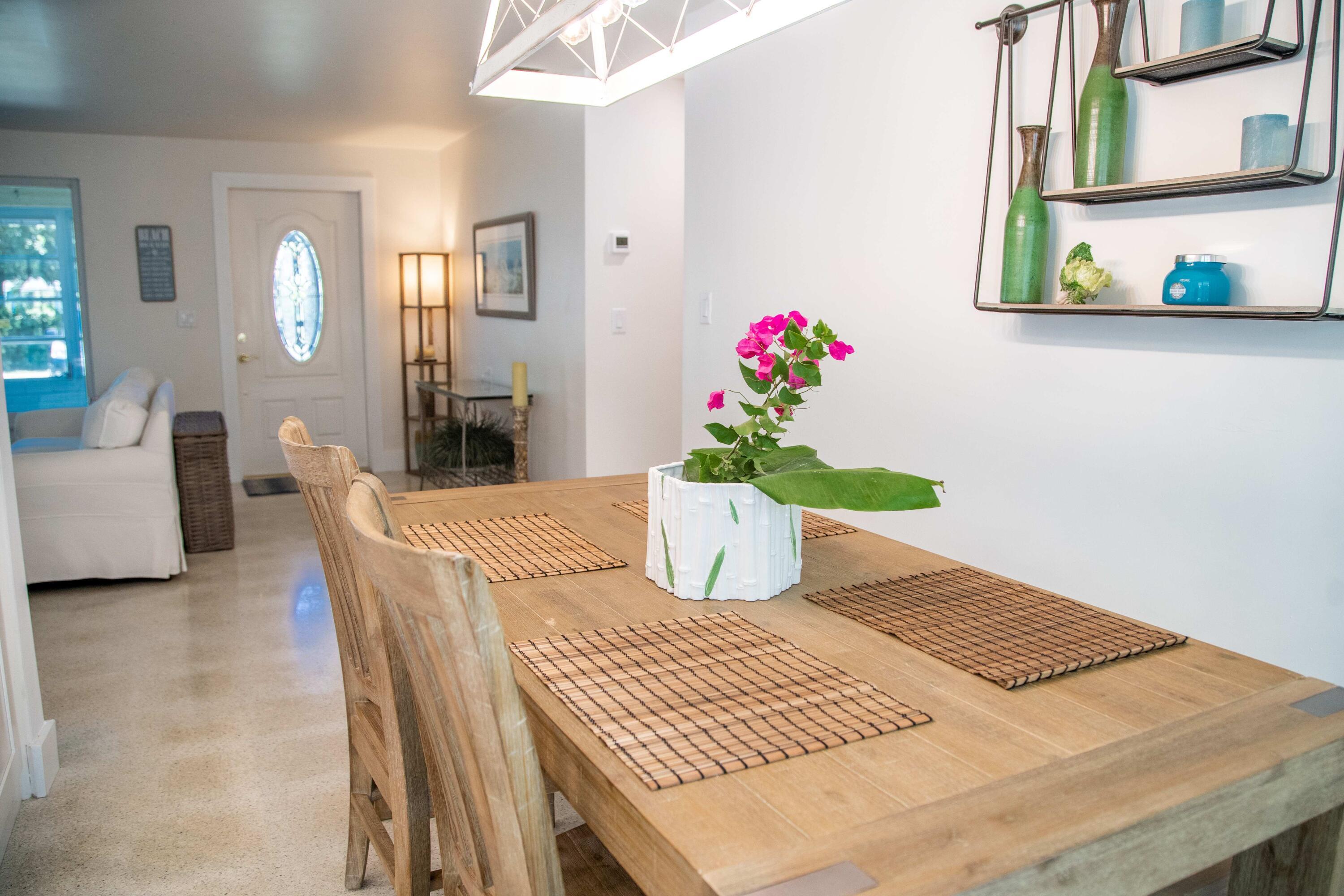 22 Van Road Jupiter, FL 33469 - Photo 24 of 38 a dining room with furniture and a potted plant