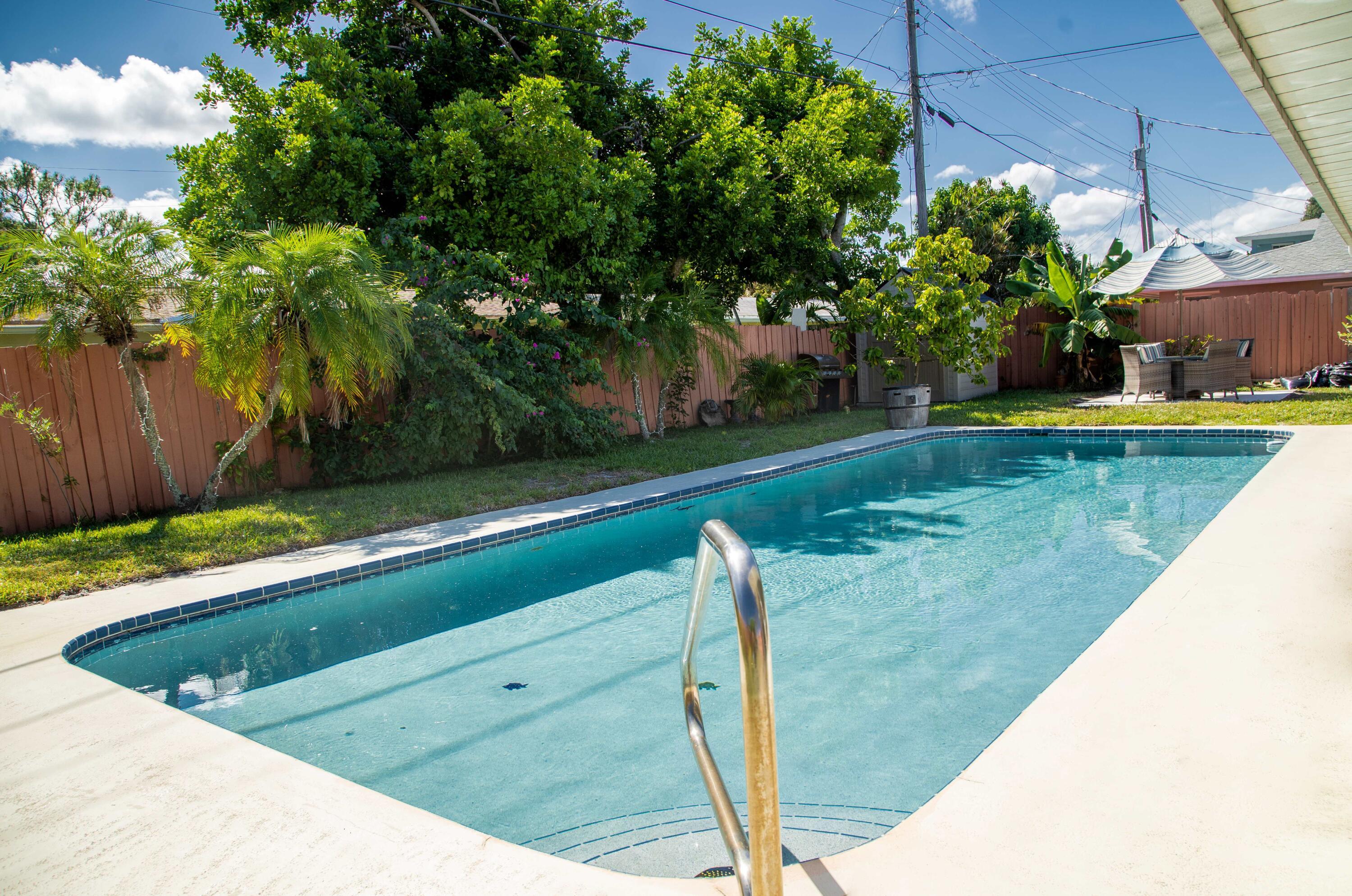 22 Van Road Jupiter, FL 33469 - Photo 27 of 38 a view of a backyard with plants and a lake view