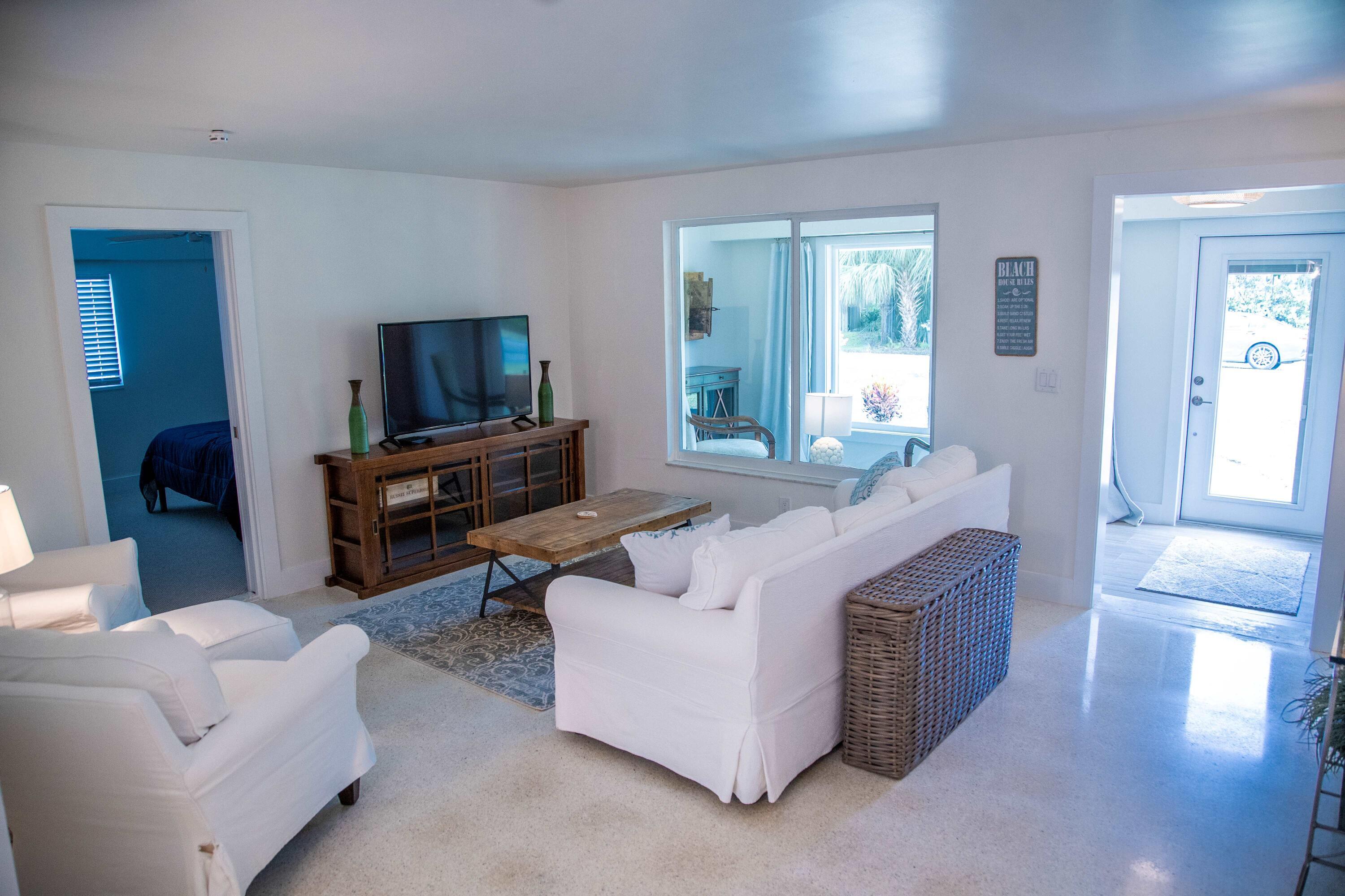 22 Van Road Jupiter, FL 33469 - Photo 32 of 38 a living room with furniture and a flat screen tv