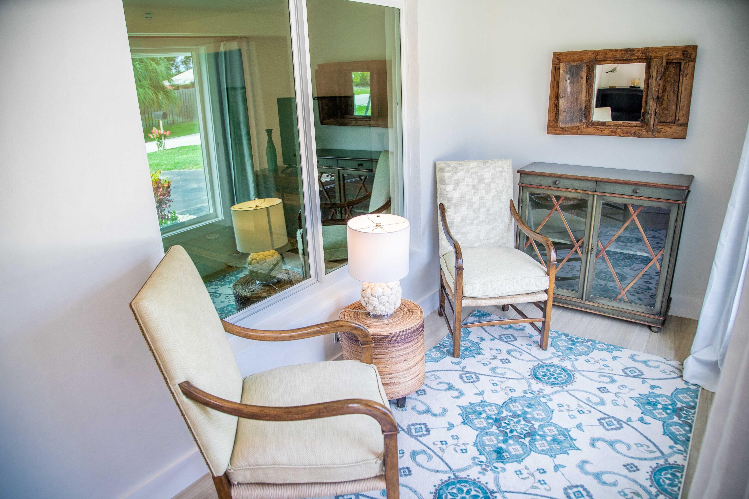 22 Van Road Jupiter, FL 33469 - Photo 33 of 38 a living room with furniture and a painting on the wall