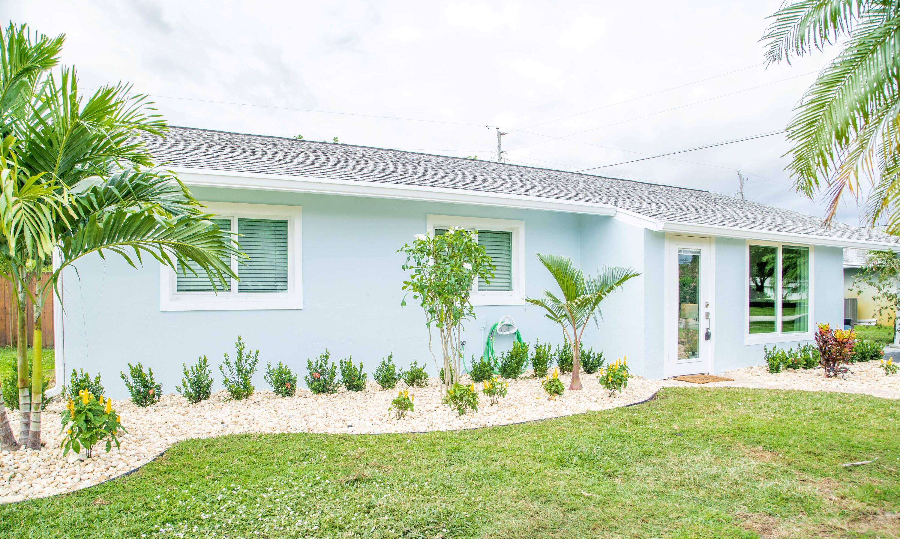 22 Van Road Jupiter, FL 33469 - Photo 36 of 38 a front view of a house with a yard