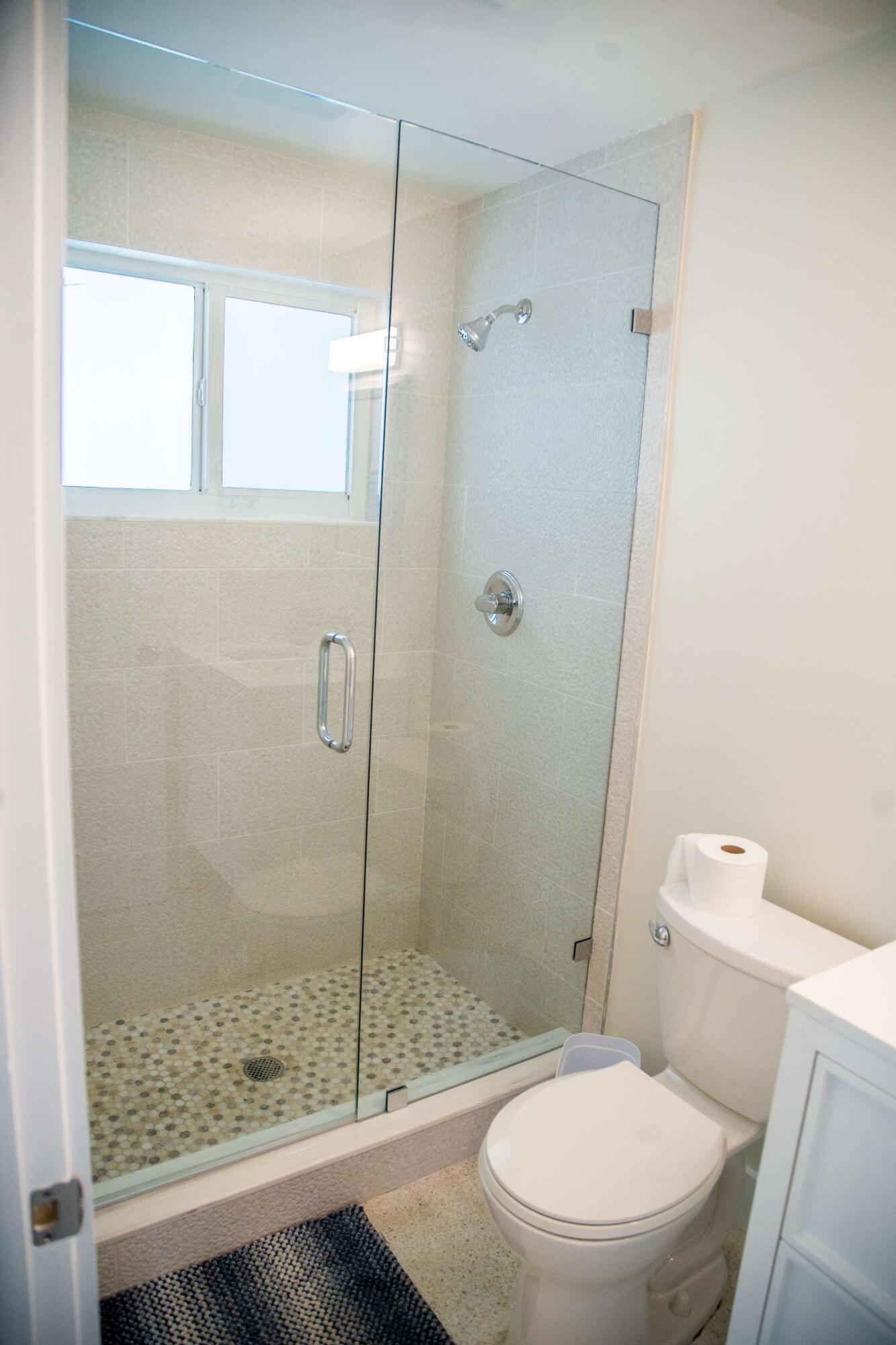 22 Van Road Jupiter, FL 33469 - Photo 4 of 38 a white toilet next to a bathroom
