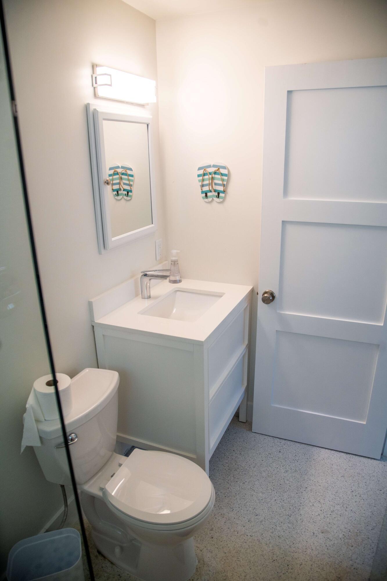 22 Van Road Jupiter, FL 33469 - Photo 5 of 38 a bathroom with a toilet sink and mirror