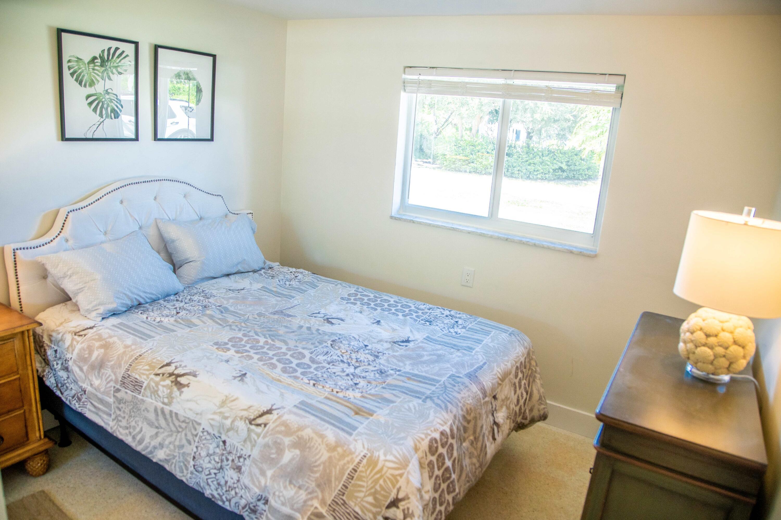 22 Van Road Jupiter, FL 33469 - Photo 6 of 38 a bedroom with a bed and wooden floor