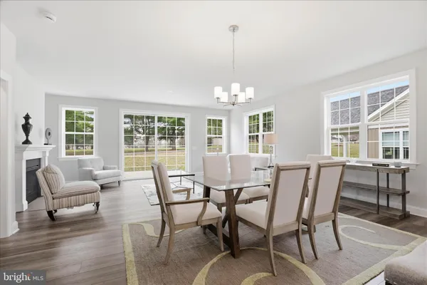 a living room with furniture a fireplace and a table