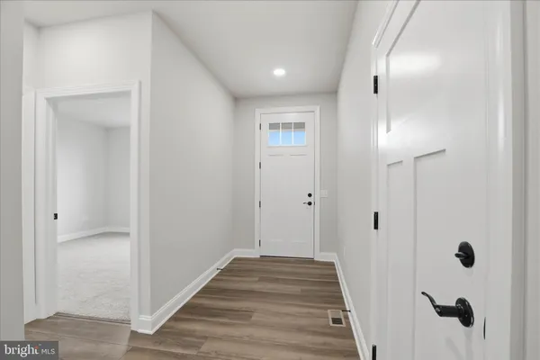 a view of a hallway with wooden floor