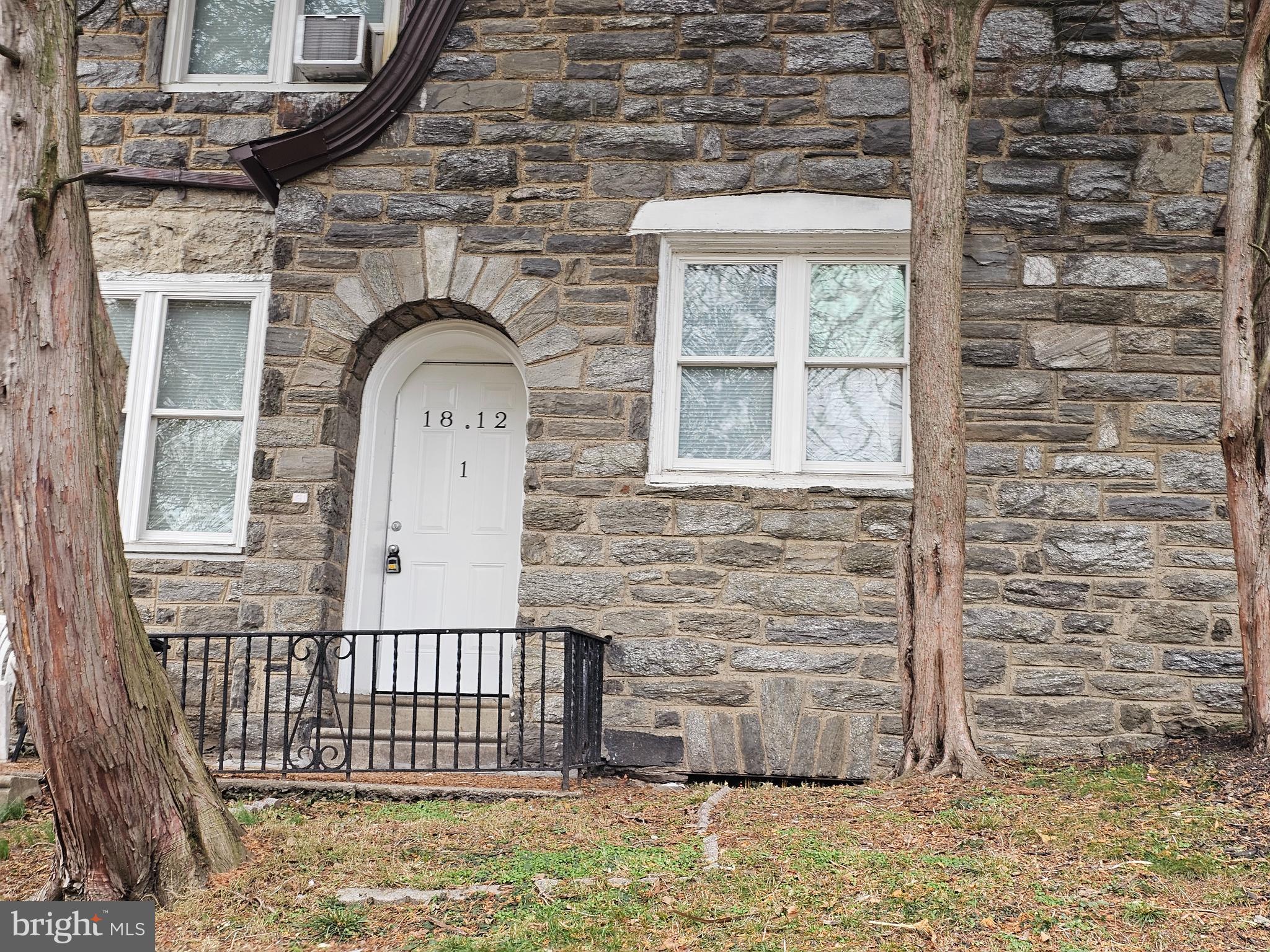 a view of a brick house with a large windows