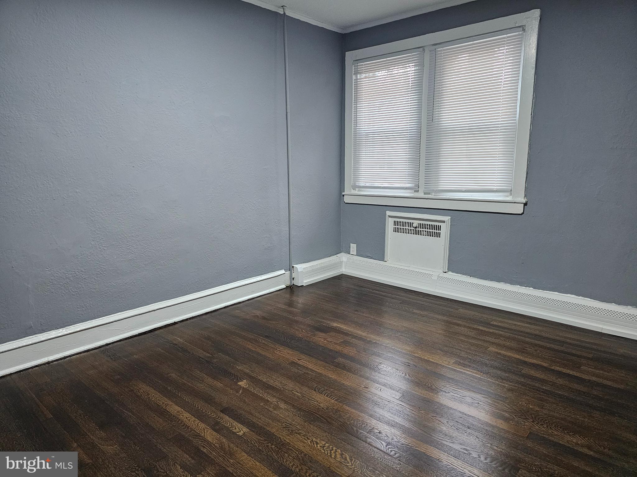 1812 North 52nd Street, Unit 1 Philadelphia, PA 19131 - Photo 8 of 9 a view of an empty room with wooden floor and a window