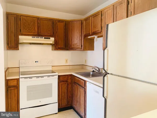 a kitchen with a sink a stove and cabinets