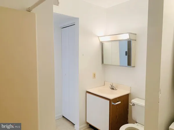 a bathroom with a sink a toilet and mirror