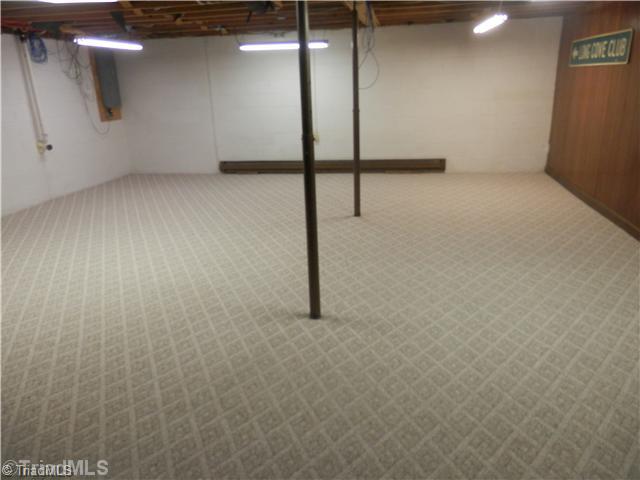 3220 Wide Country Road Pfafftown, NC 27040 - Photo 16 of 16 Playroom. Lower level playroom or office with fireplace. Newly installed carpet.