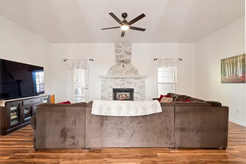 a backyard of a house with lots of green space and fountain